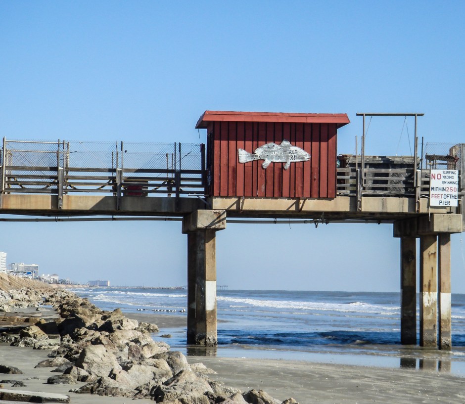 A vintage pier with the city in the distance