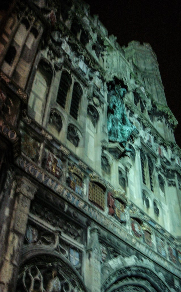 City lights reflect on the exterior of Canterbury Cathedral
