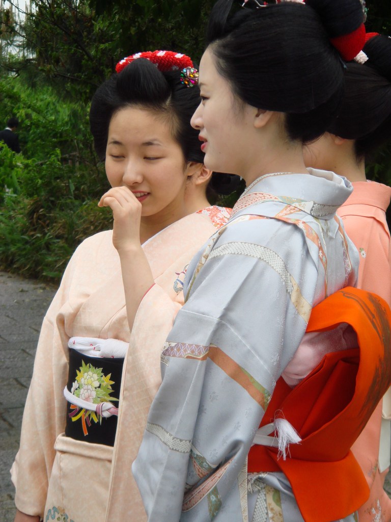 A group of geisha women chat together in Kyoto