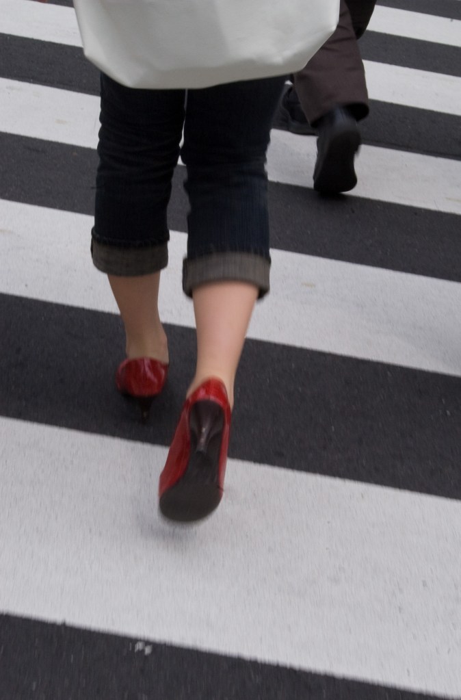 A woman crosses the street in Kyoto