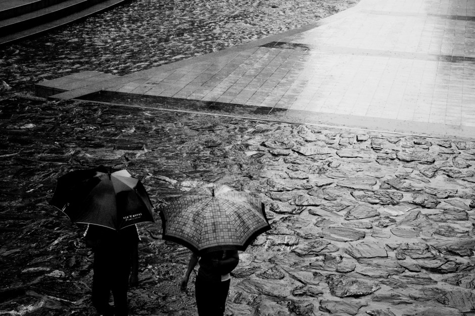 Umbrella laden people stroll during a rainy holiday in Seoul