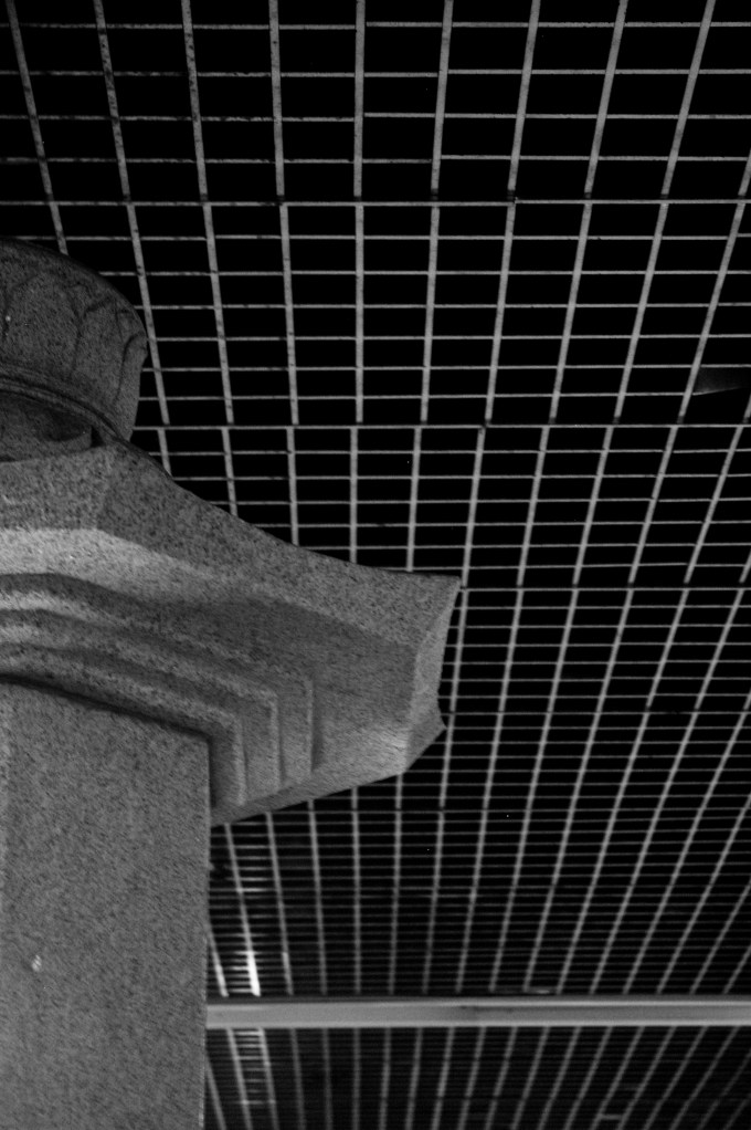 A traditional stone support lines the hallways of the subway line under Gyeongbokgung Palace