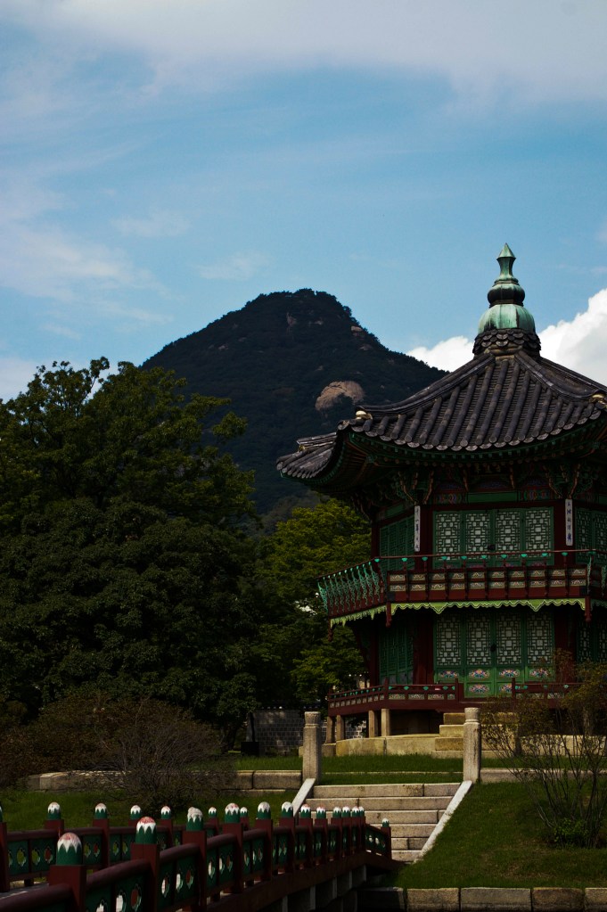 A palace building seen against a nearby mountain