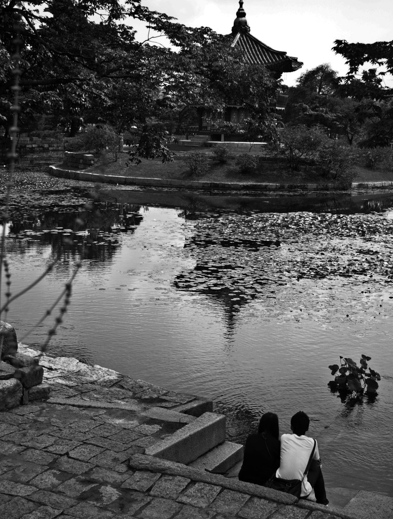 A young couple takes in the beauty of the palace landscaping in Gyeongbokgung