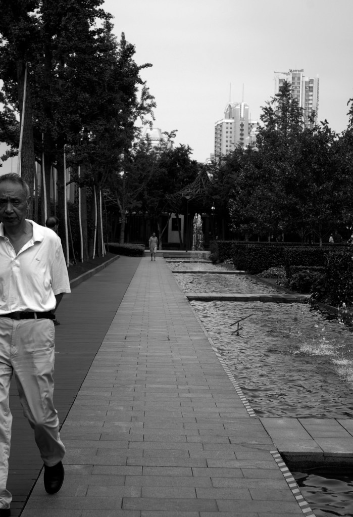 A man strolls through the Jing'an Sculpture Park