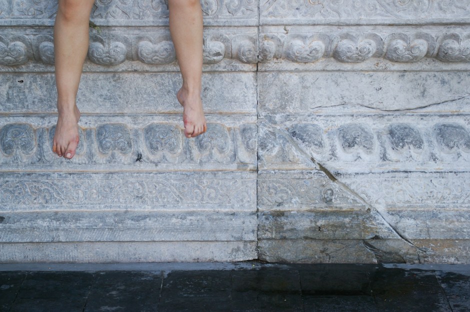 A tourist takes a break in the Forbidden City
